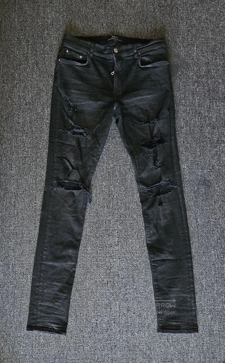 Amiri Distressed Coated Denim Jeans.