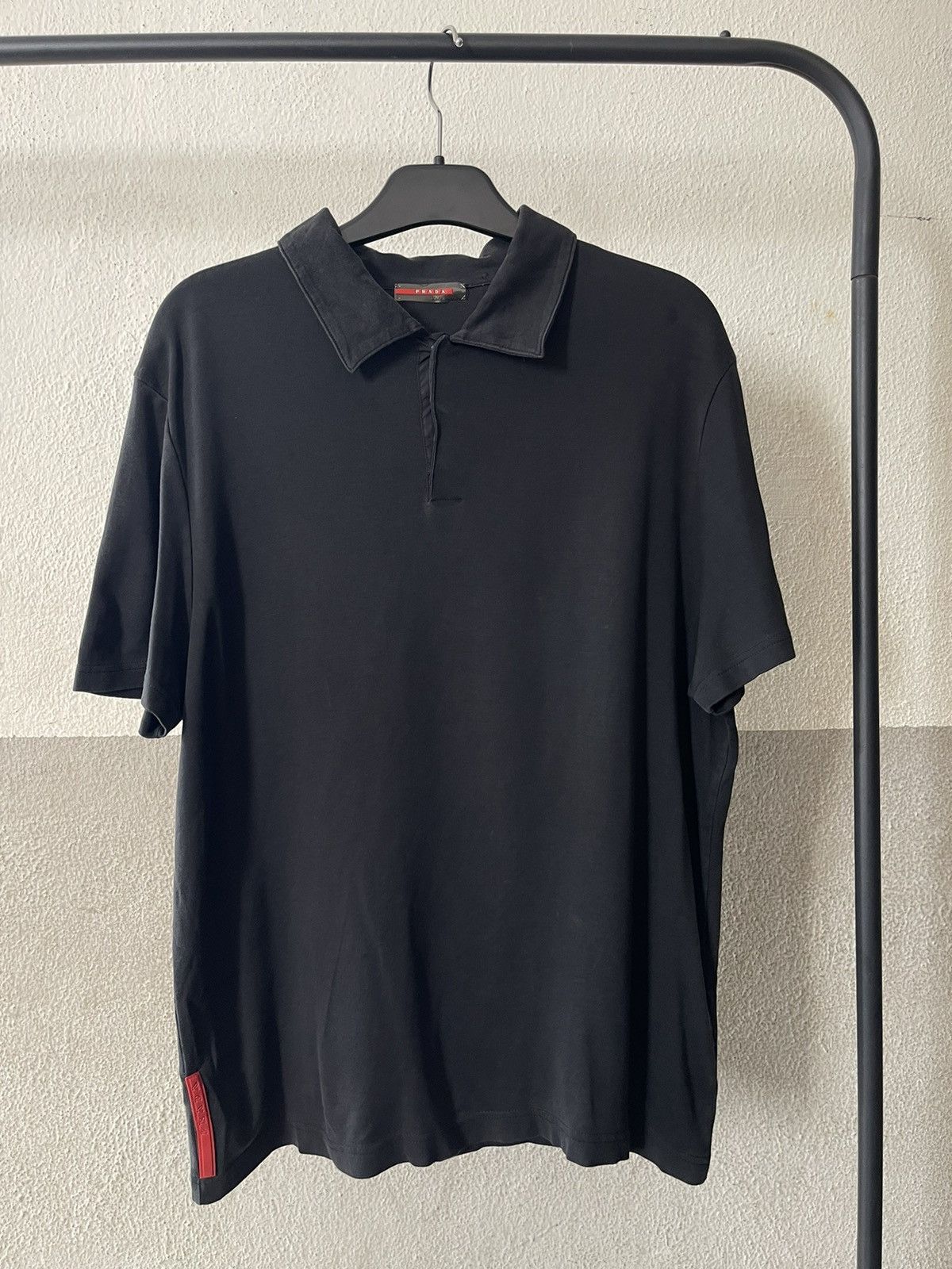 Prada Polo with iconic red rubber logo | Grailed