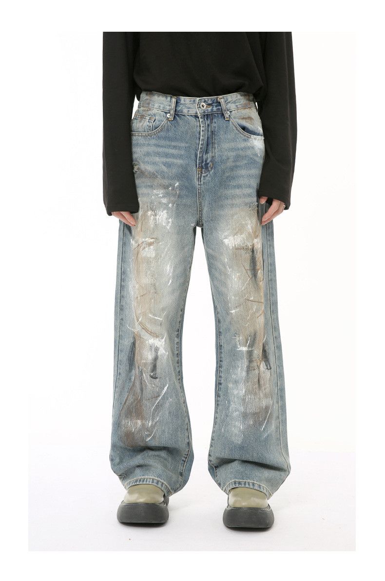 Washed and distressed style dirty graffiti jeans