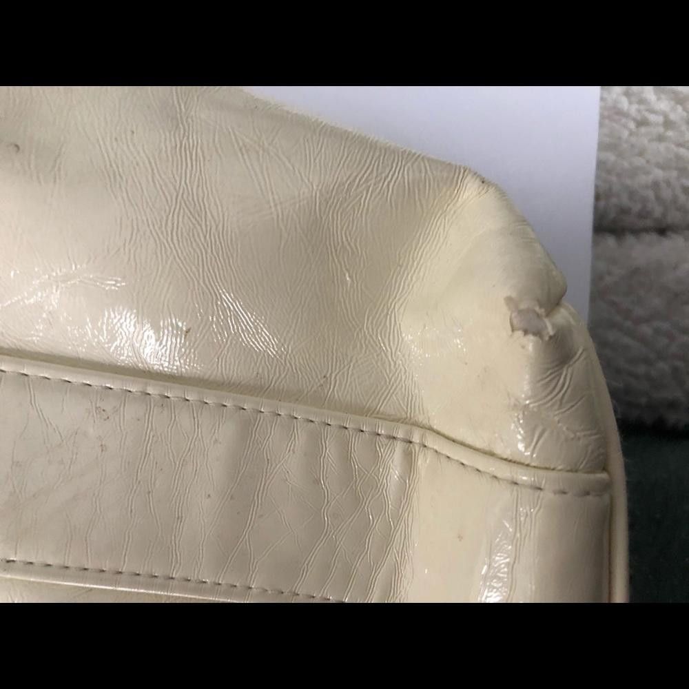 Cream hobo bag with silver plates on straps