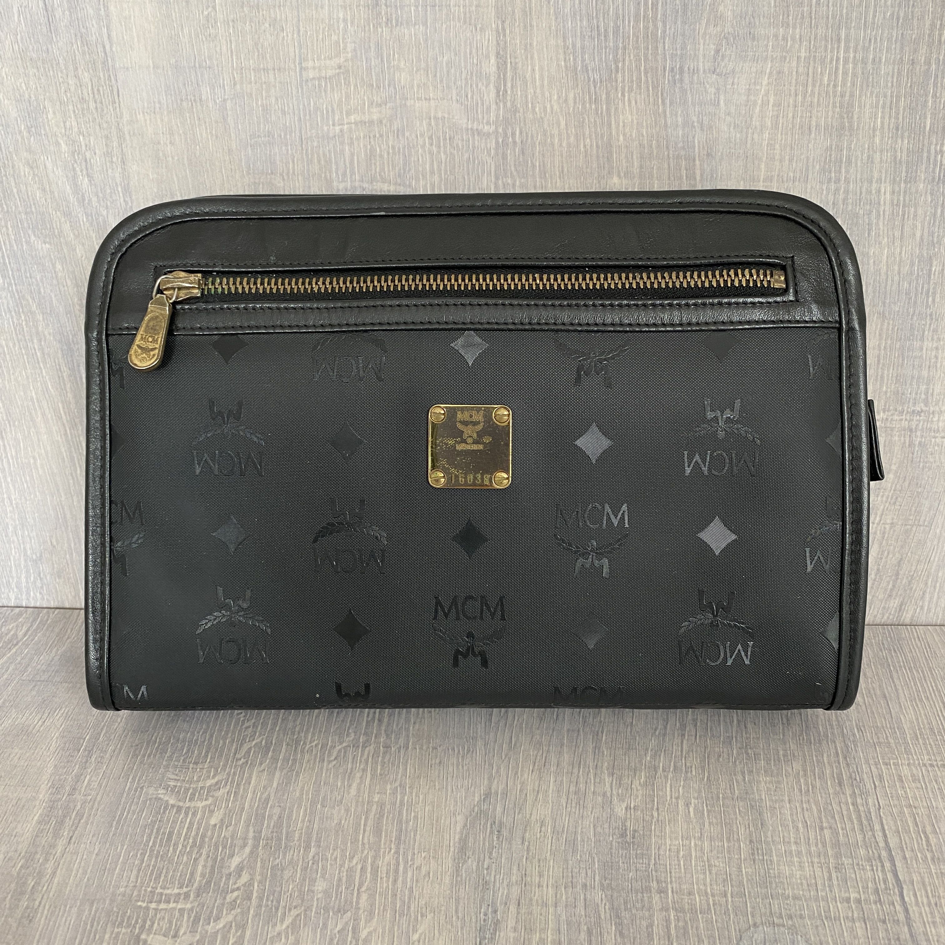 image of MCM All-Over Pattern Leather Clutch Bag Black, Men's