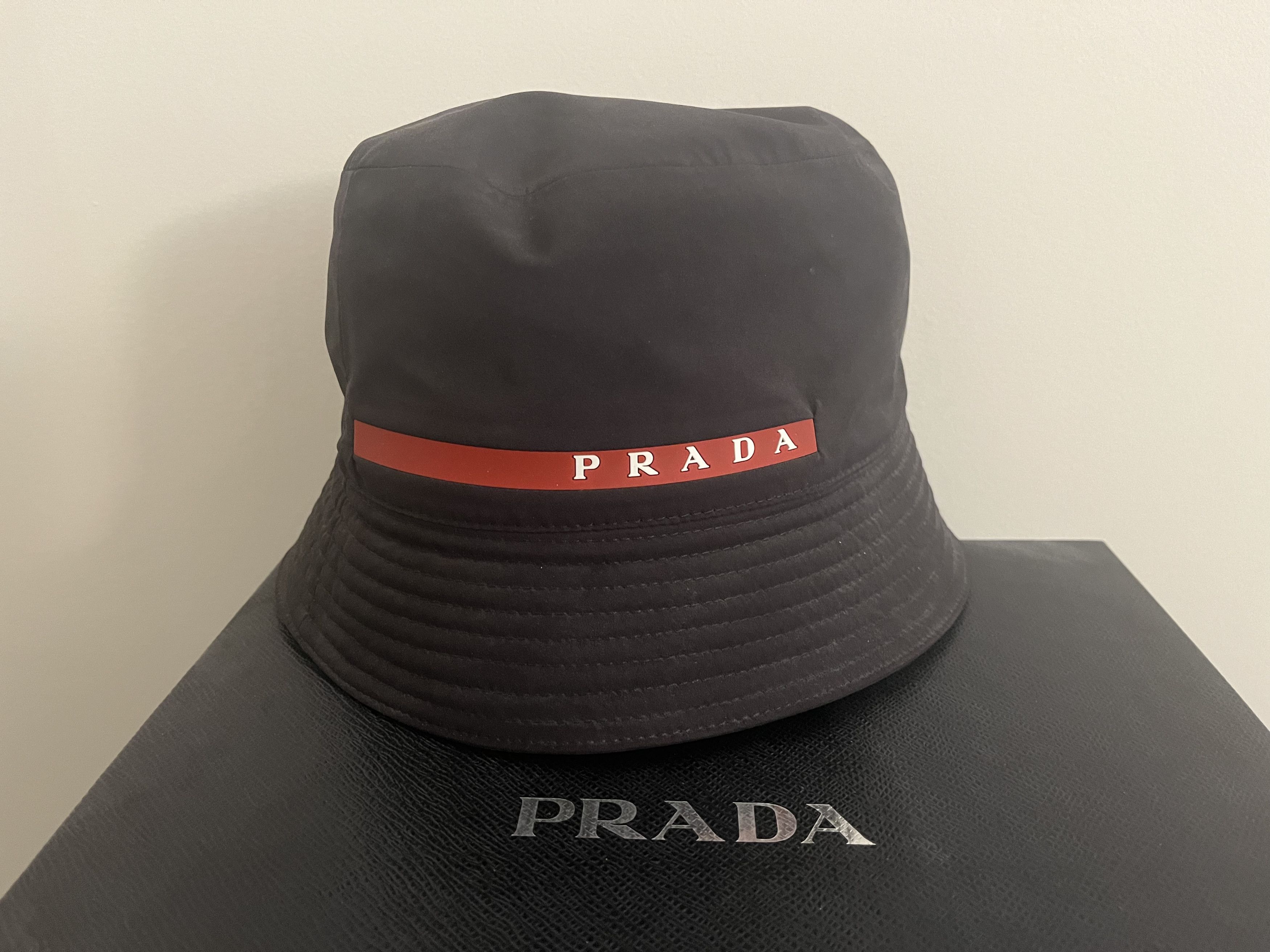 Prada PRADA BUCKET HAT BLACK NYLON RED WHITE RUBBER LOGO | Grailed