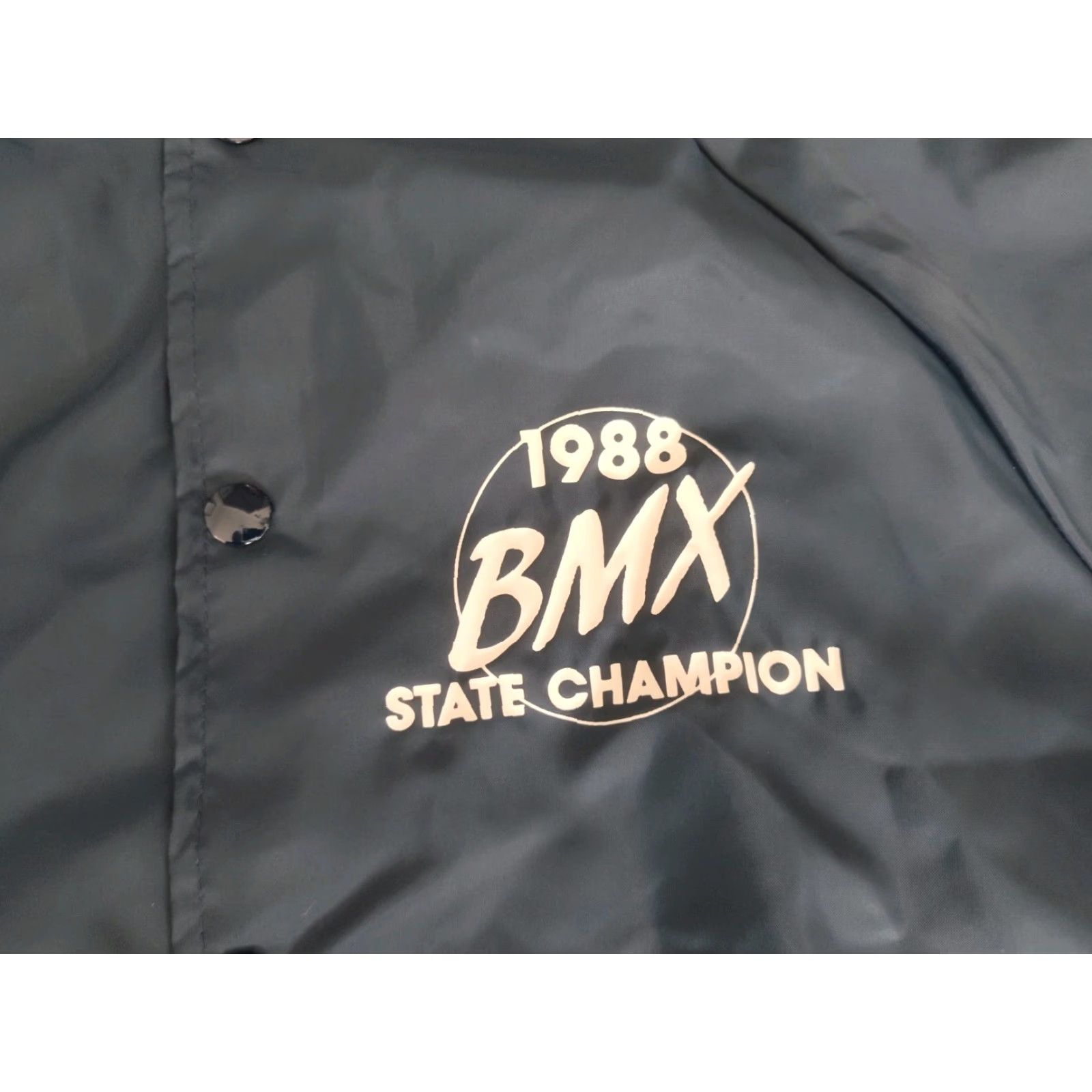 Augusta Sportswear VINTAGE Augusta Sportswear Satin Bomber Jacket Mens 1988 Michigan BMX State Champion Dark Blue Short Sleeve Casual Winter Summer Spring Fall Sz L Size US L / EU 52-54 / 3 - 3 Thumbnail