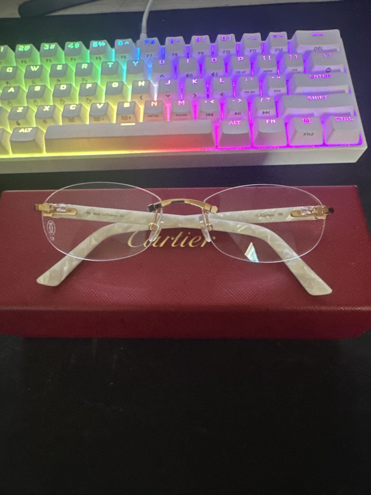 image of Cartier C Decor Rimless Oval-Frame Glasses in White, Men's