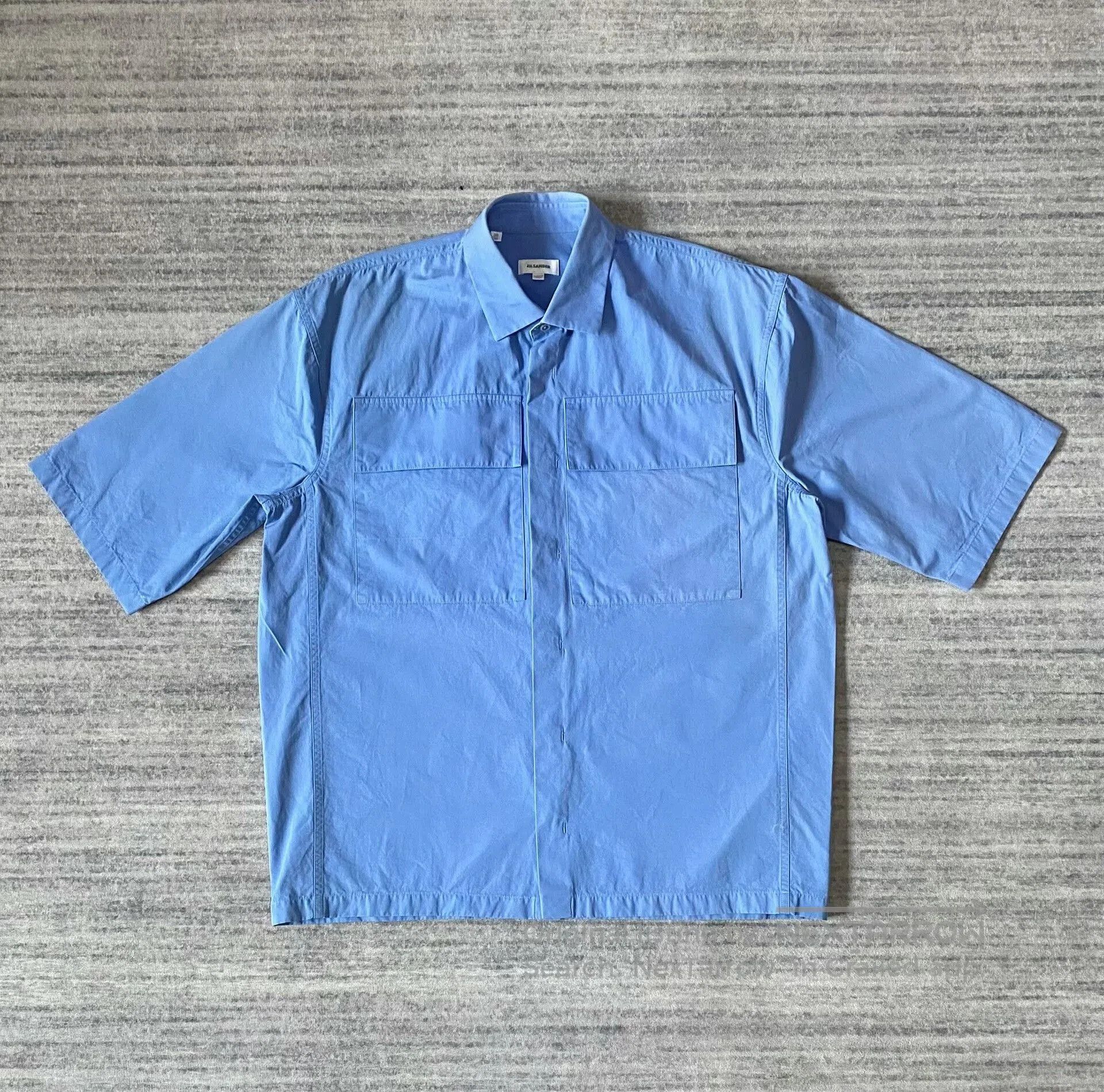 blue short sleeve utility shirt.