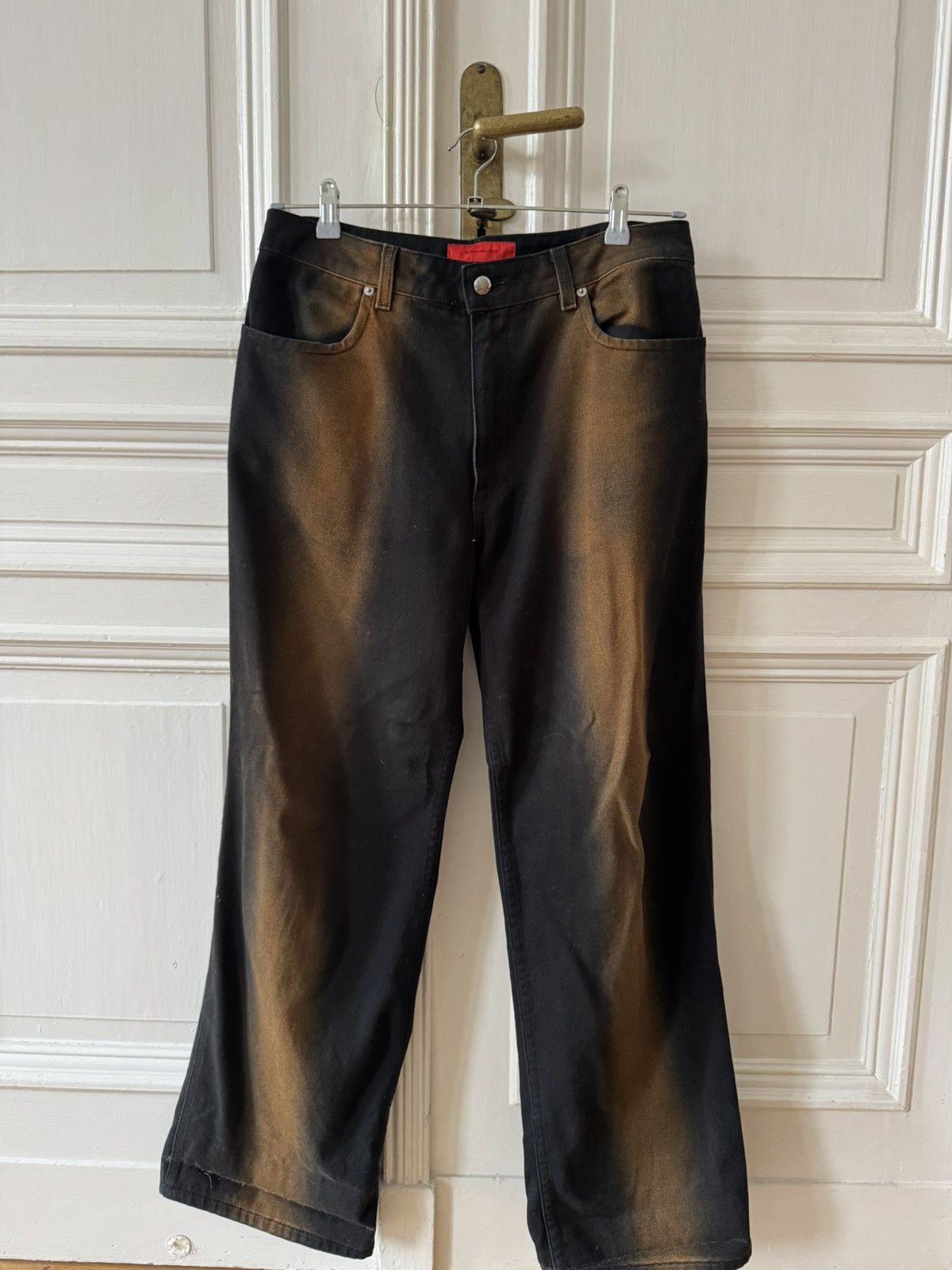 Eckhaus Latta wide leg black denim jeans with orange bleach