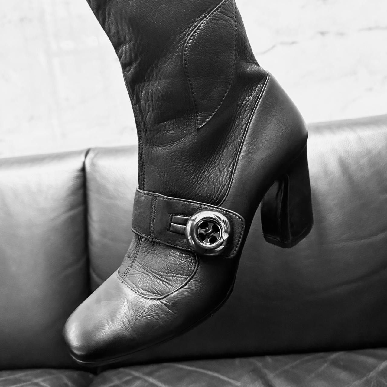 Prada archive leather boots asymmetric heel button detail.
