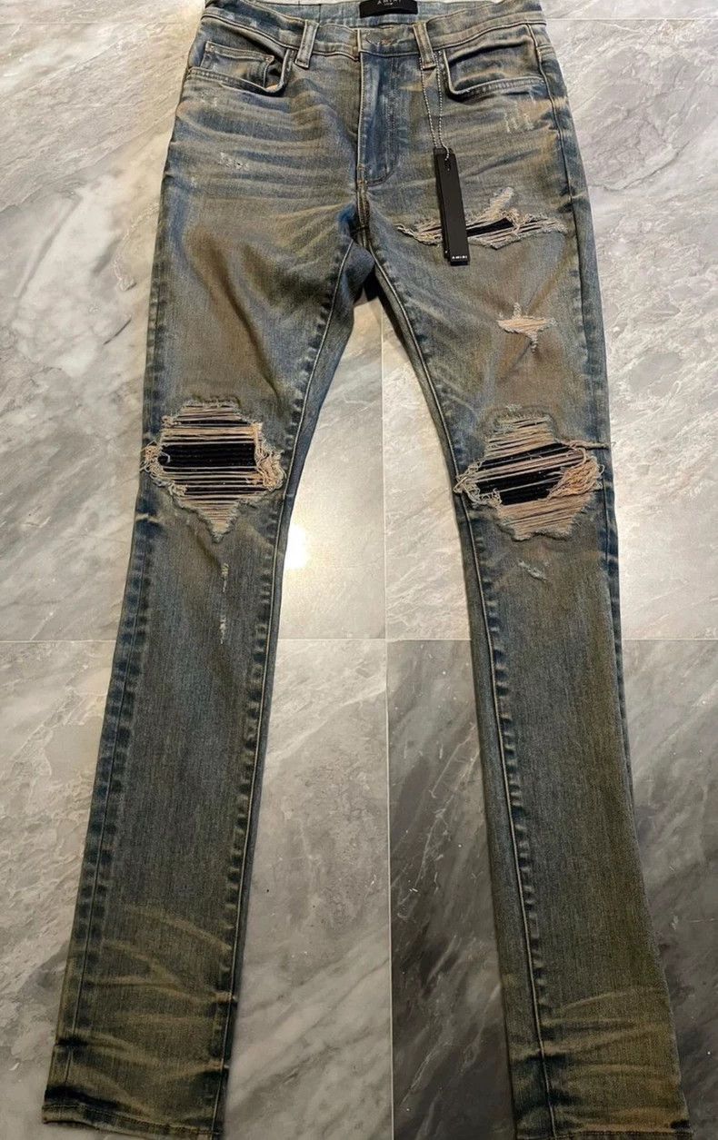 Amiri yellow mud glitter patched blue jeans