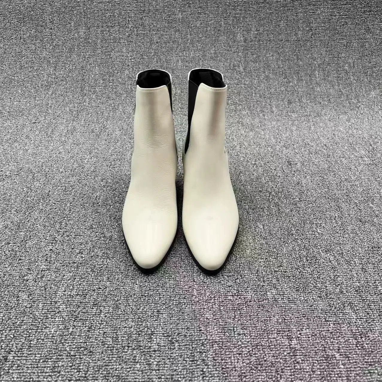 white leather pointed toe chelsea boots.