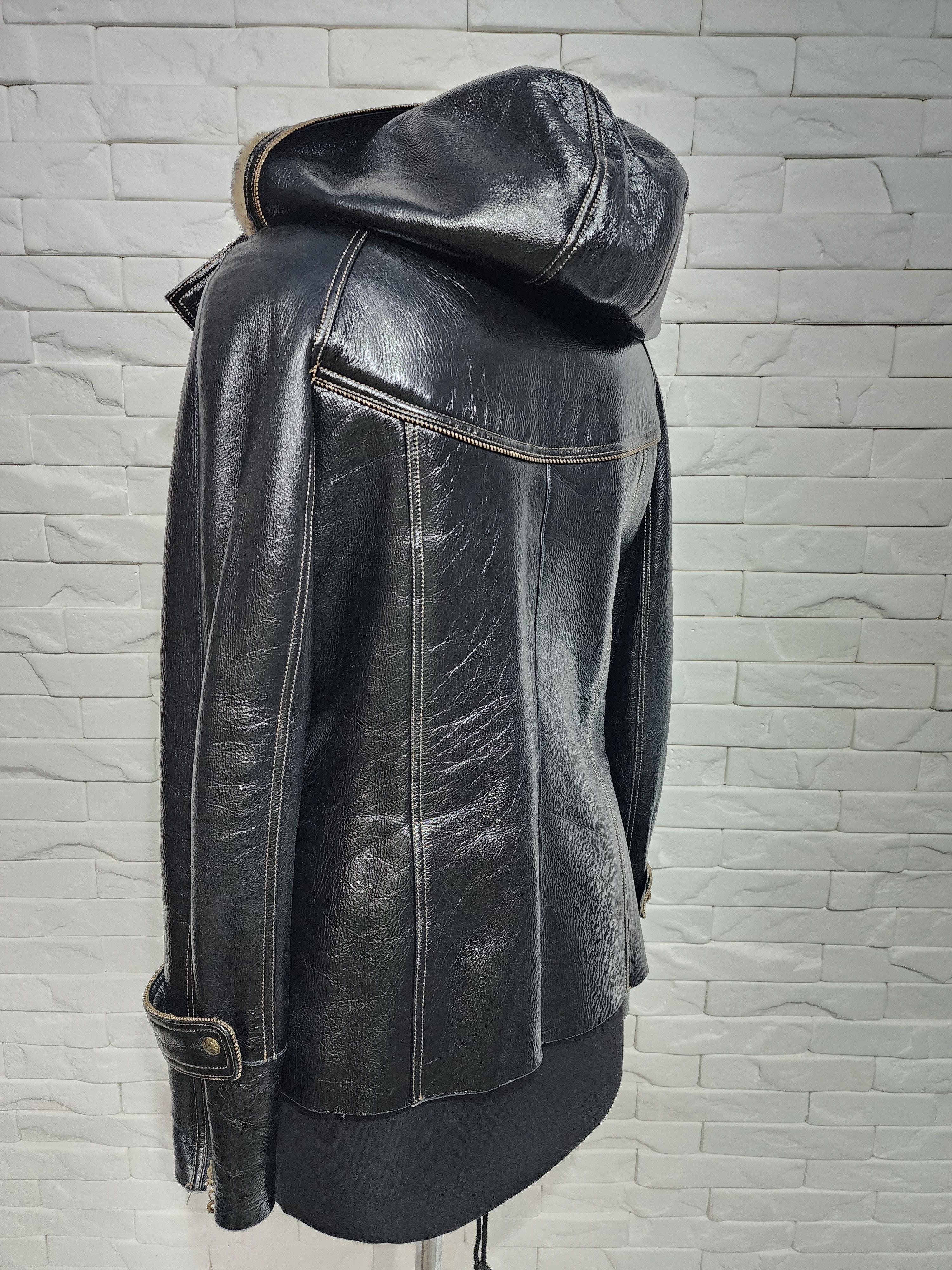 Black sheepskin coat with a metal zipper and hood.