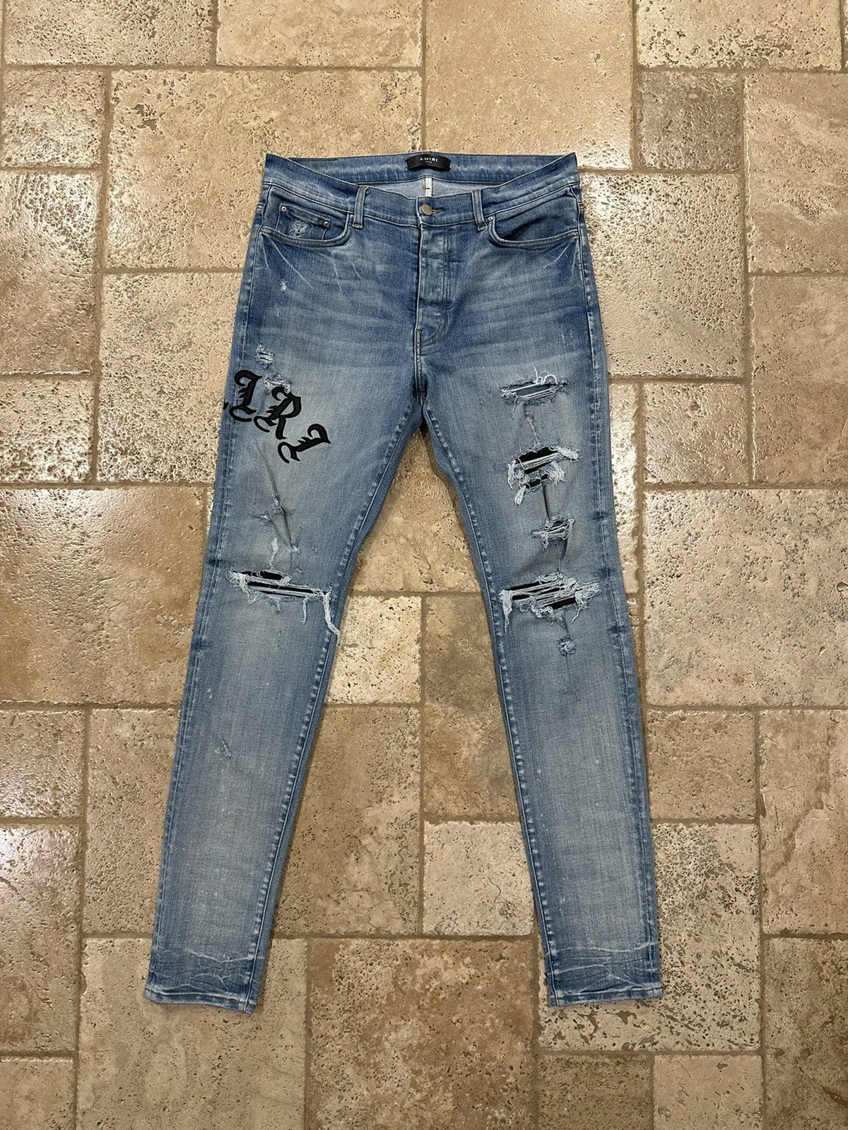 image of Amiri Old English Leather Logo Clay Indigo Denim Jeans in Blue, Men's (Size 36)