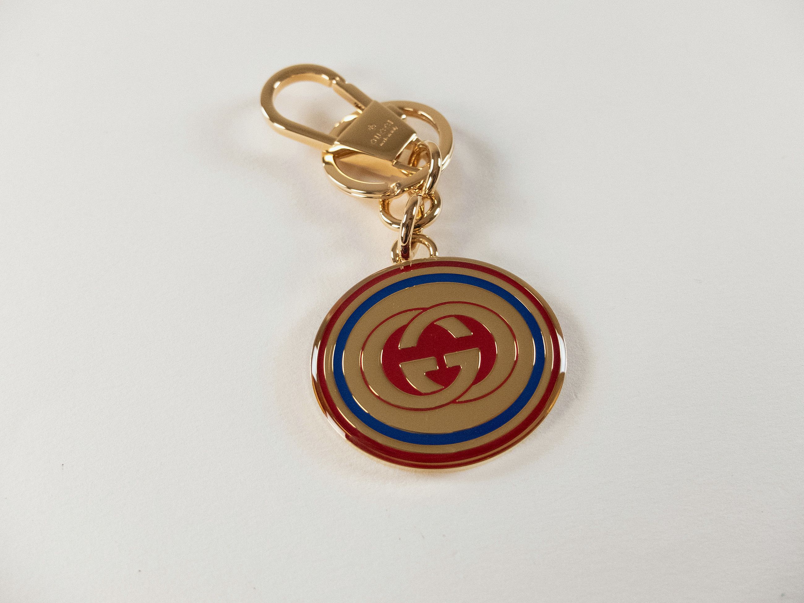 GUCCI gold tone enameled interlocking G logo metal keyring