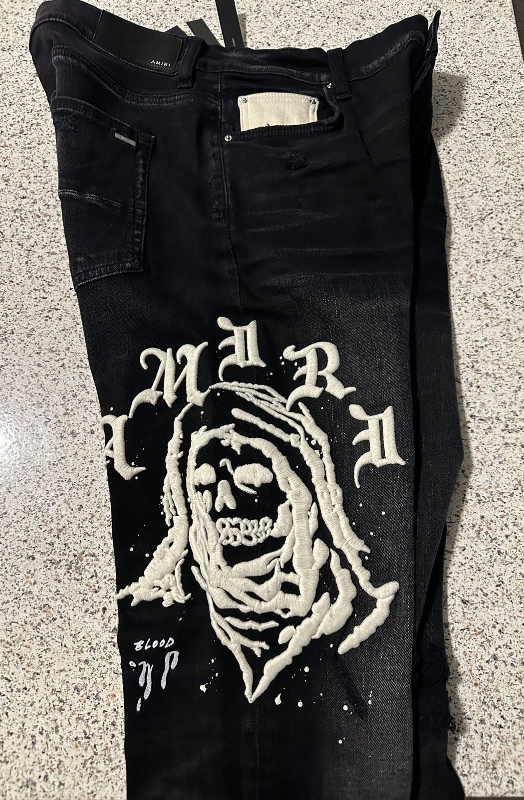 image of Amiri Wes Lang Reaper Logo Jeans in Black, Men's (Size 33)