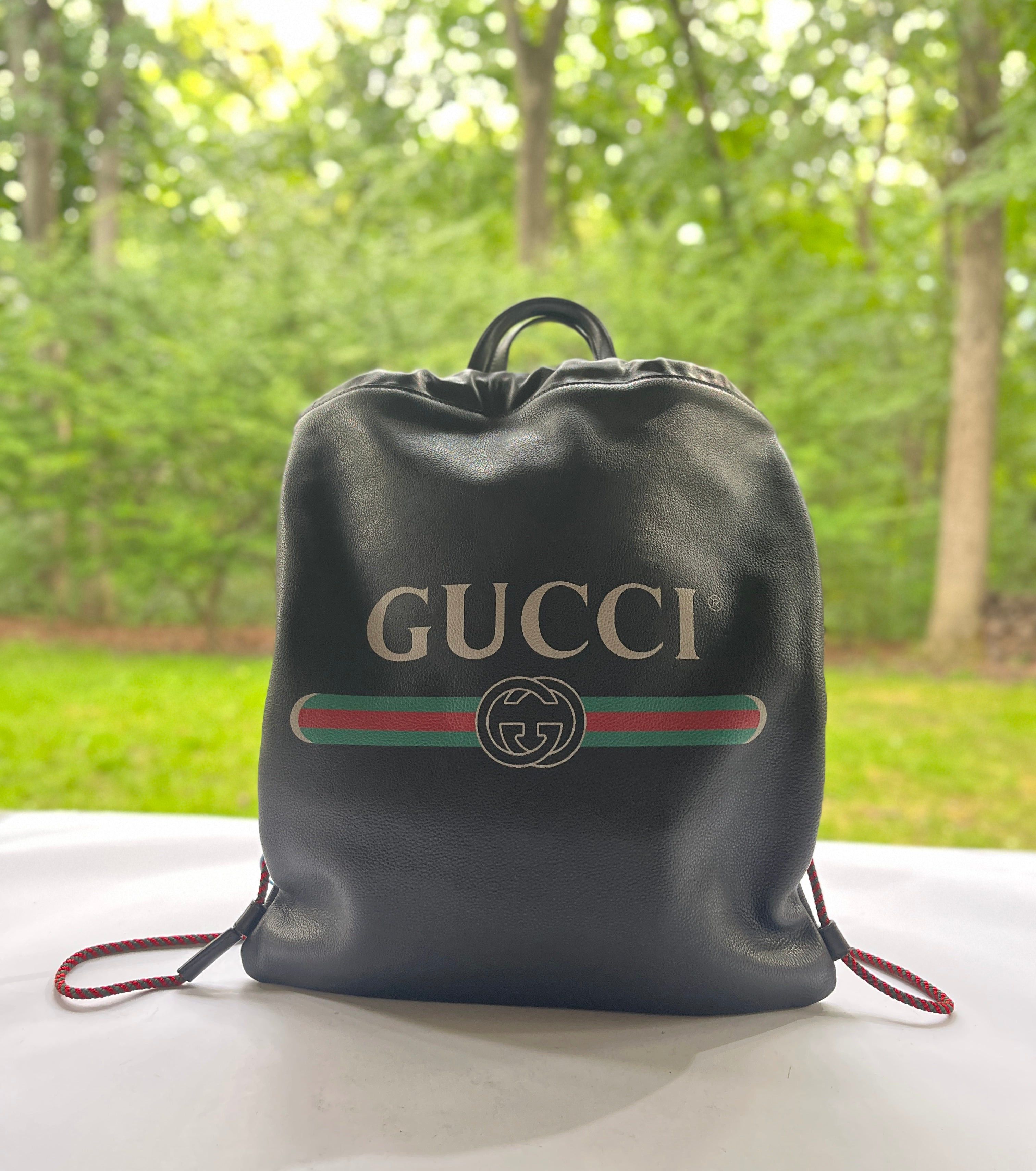 Gucci Gucci Leather Printed Logo Drawstring Backpack Black Grailed