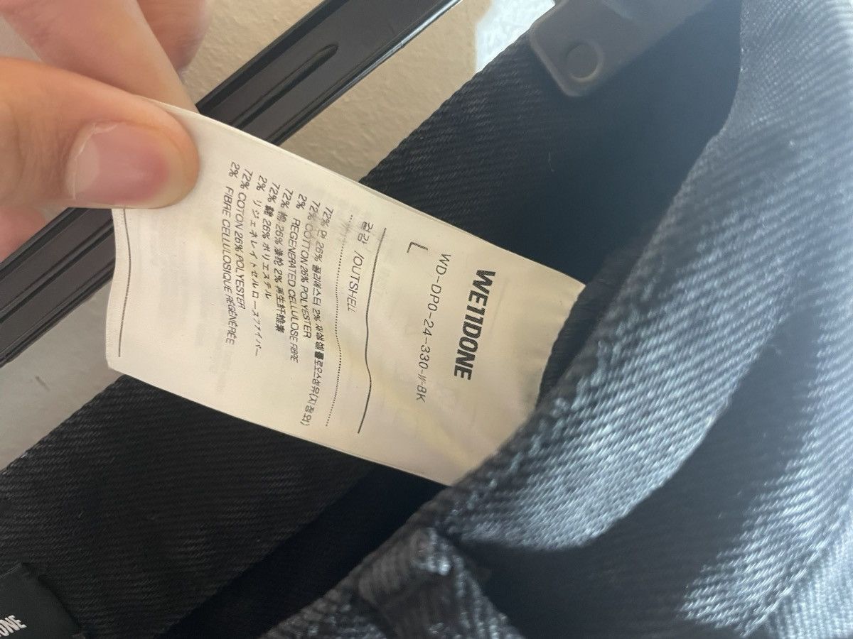 WE11DONE black distressed jeans