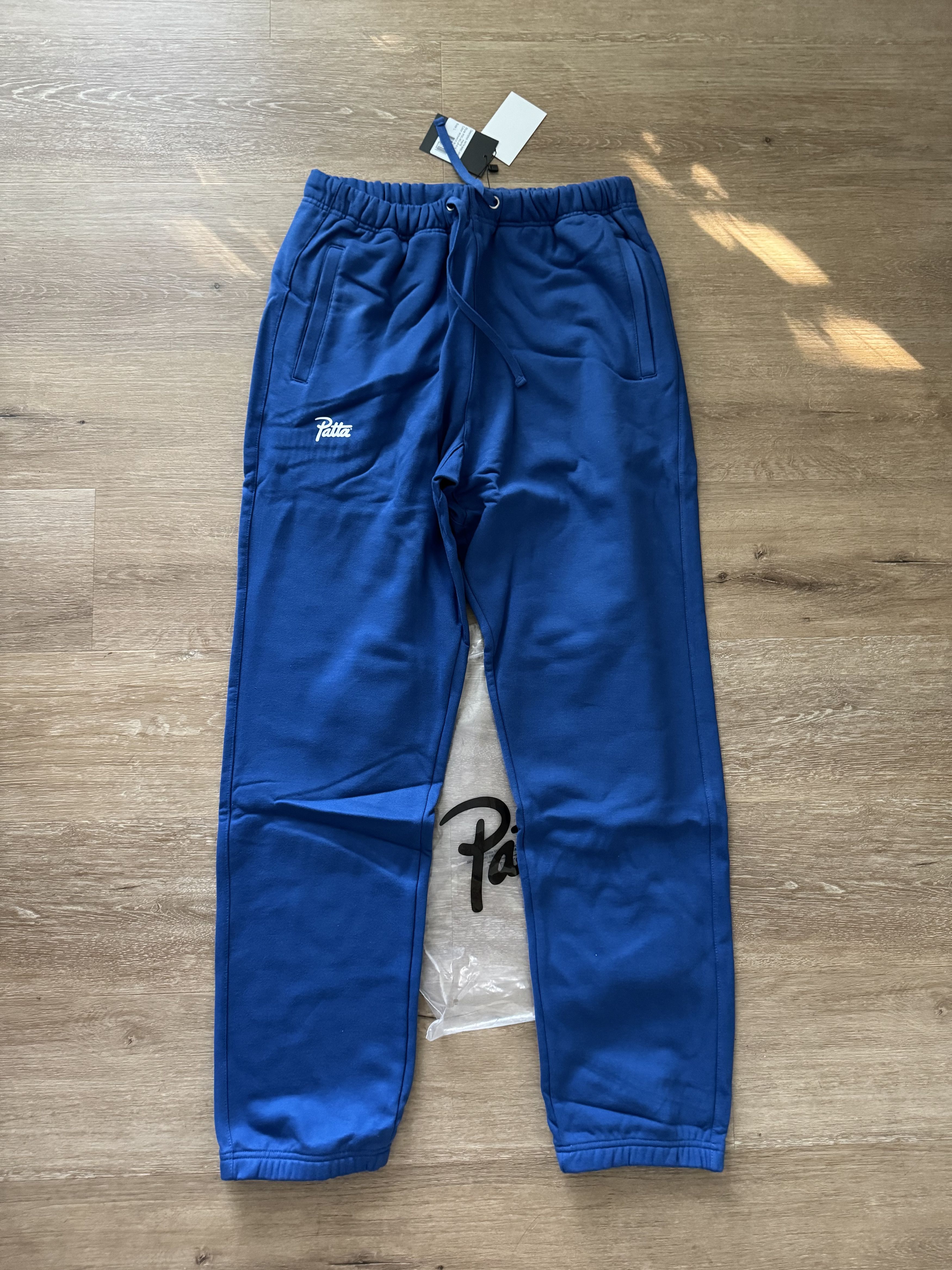 image of Patta Cursive Logo Cotton Taper Track Pants In Blue - Large in Deep Blue, Men's (Size 36)