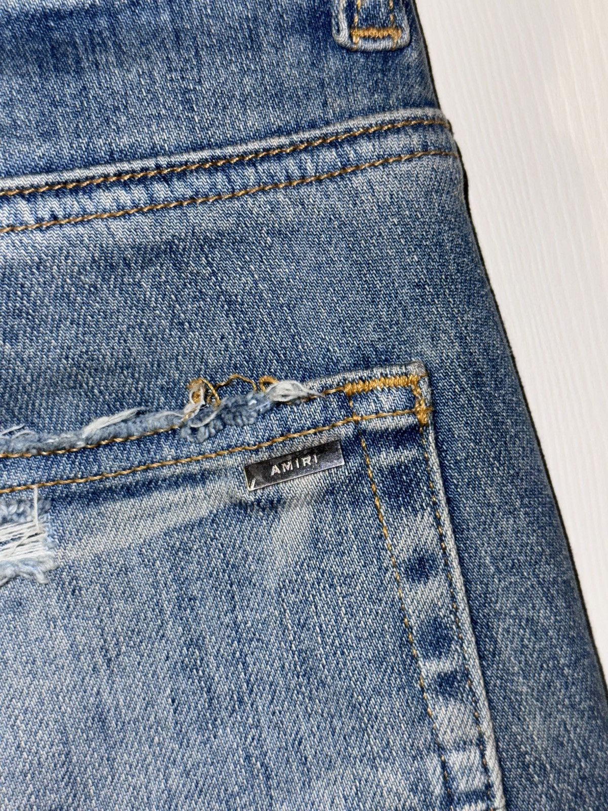 AMIRI BLUE DISTRESSED JEANS