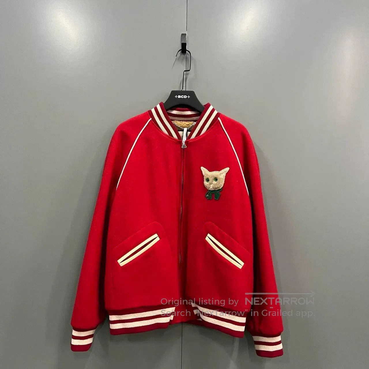 red gucci baseball jacket with white trim.