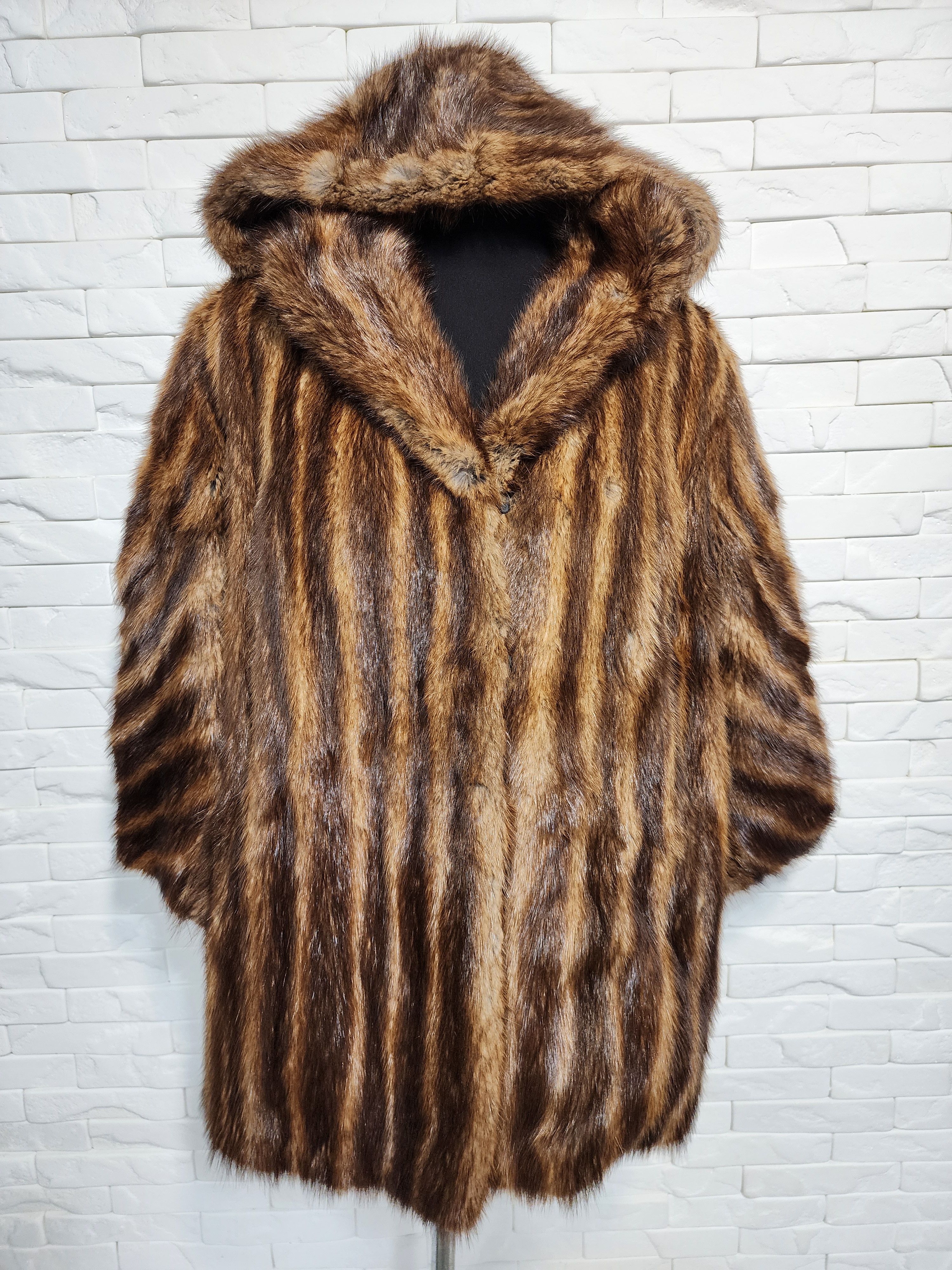 Warm brown women's fur coat with hood.