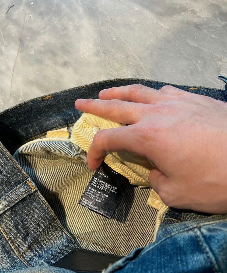 Amiri yellow mud washed blue jeans