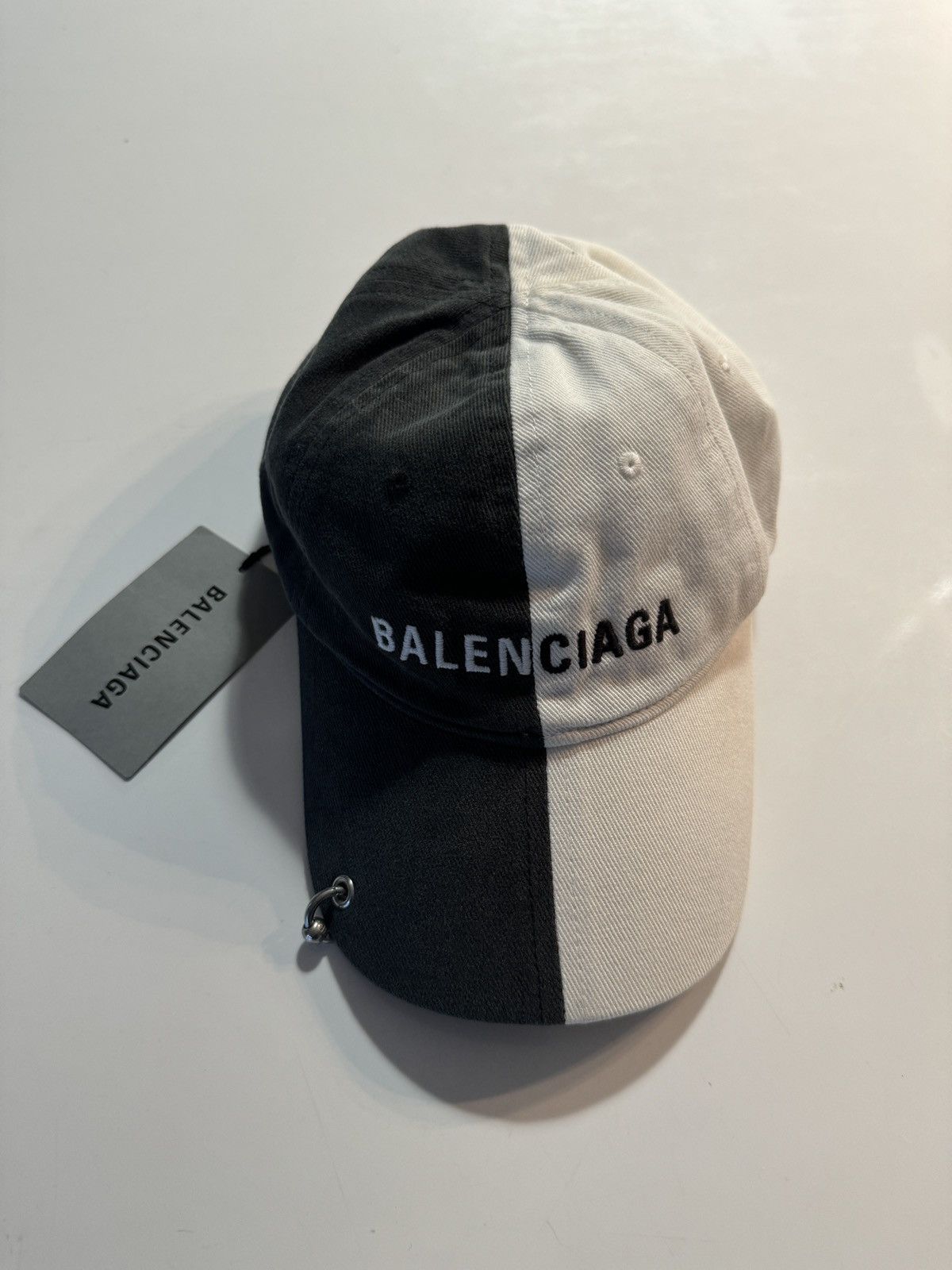 image of Balenciaga Half Split Cap Piercing L in Black, Men's