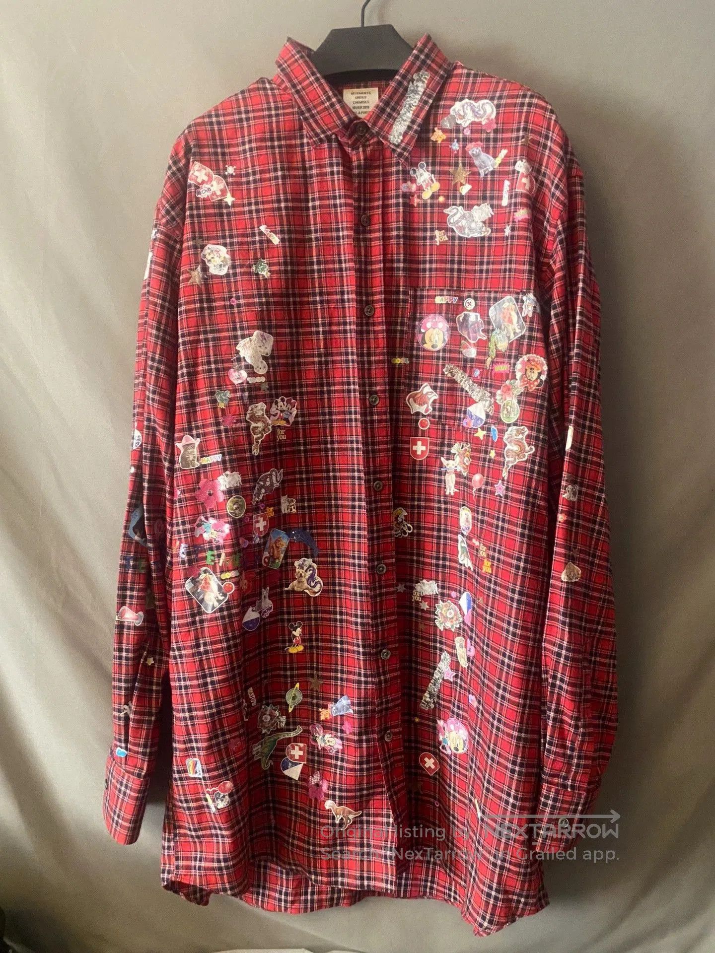 vetements red plaid shirt with stickers.