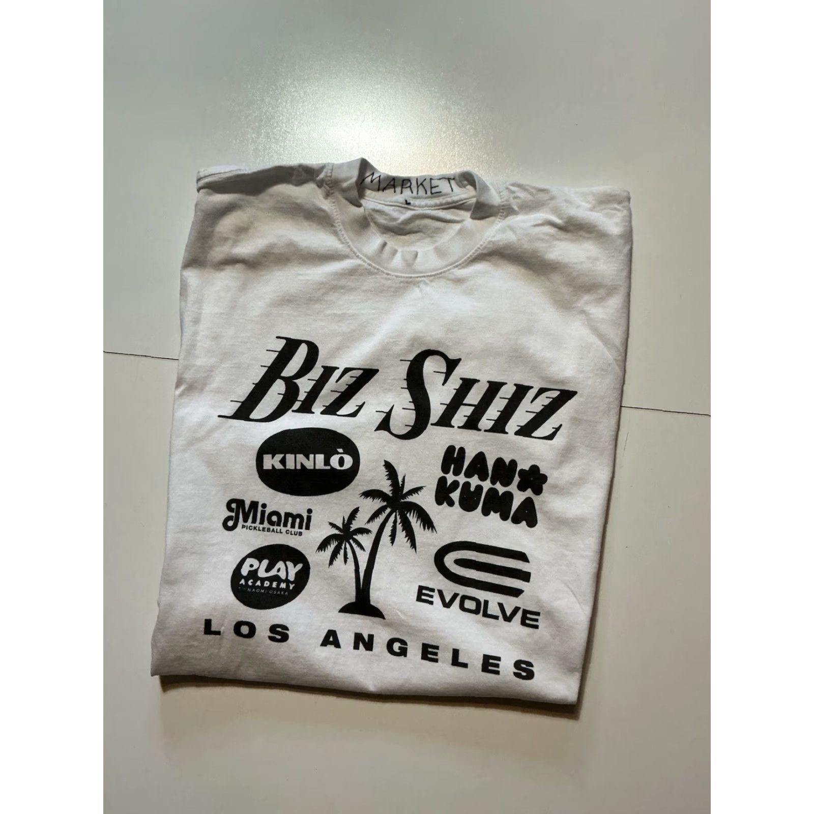 Market Market Studios Los Angeles Sponsor Graphic White Short Sleeve T-Shirt LG Men Shirt Angel 90s? Size US L / EU 52-54 / 3 - 2 Thumbnail