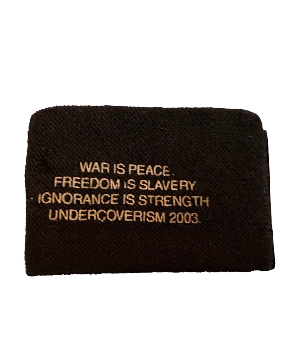 image of Aw03 Undercover Archive Paper Doll War Is Peace Wristband in Black, Women's