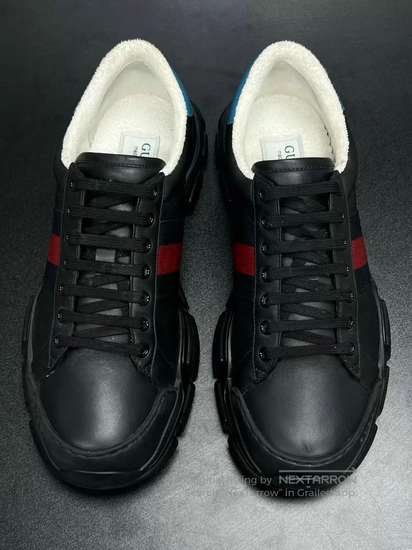 Black Low-Top Sneakers with Red and Blue Stripes.