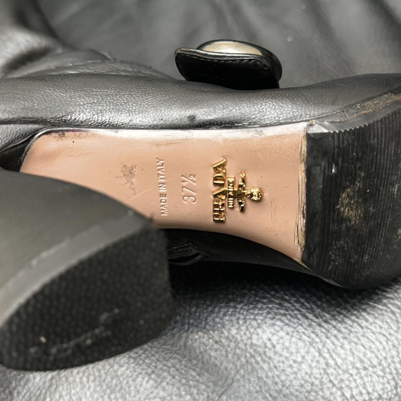 Prada archive leather boots asymmetric heel button detail.