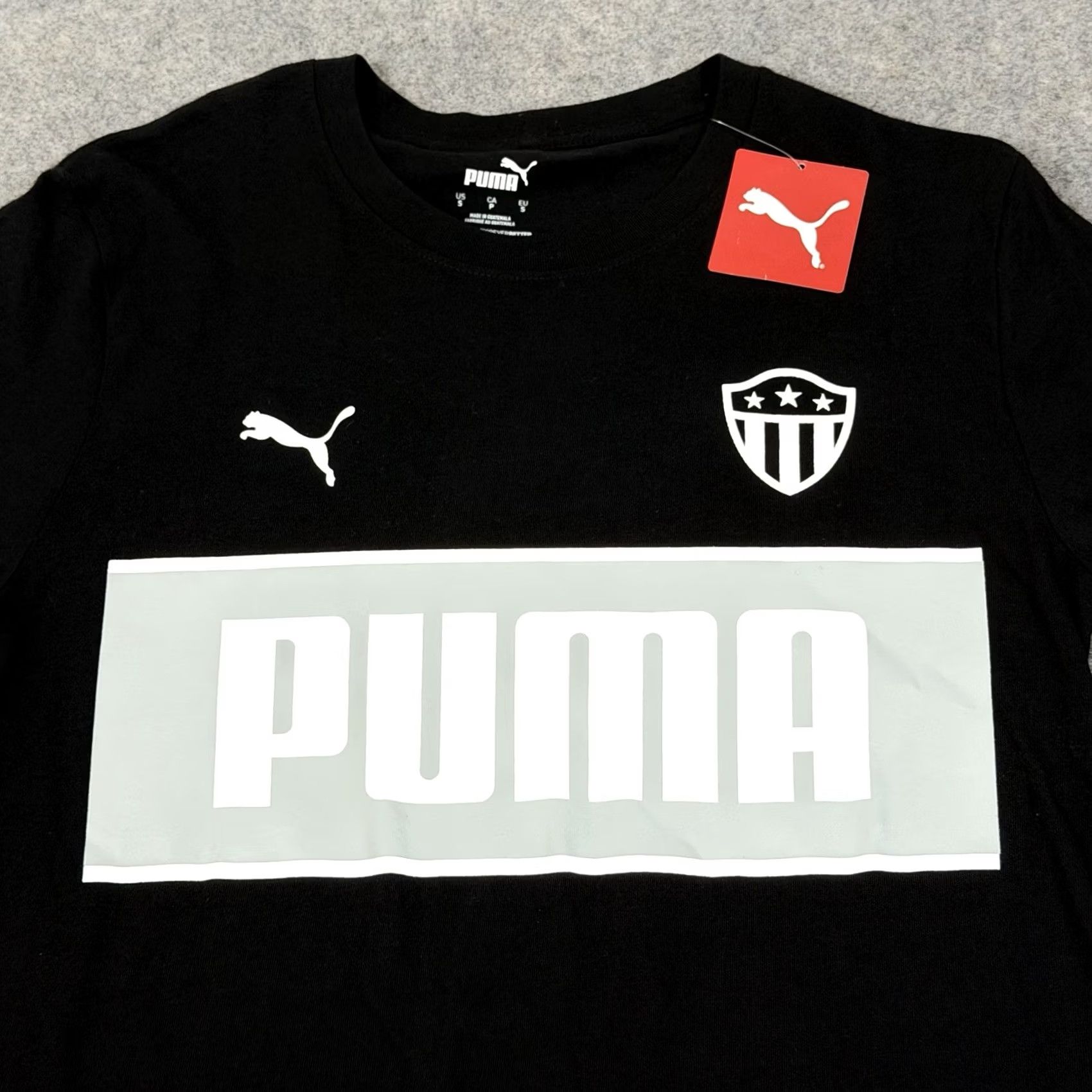 Puma Puma Soccer Shield Badge Sport Short Sleeve T-Shirt Mens Black Small Cotton Knit Shirt 38in Chest 28.5in Length Size US S / EU 44-46 / 1 - 2 Thumbnail