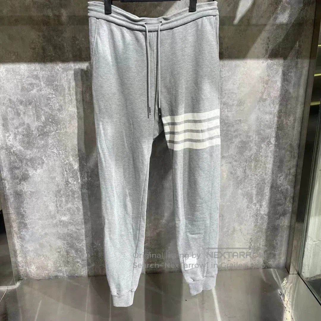 thom browne gray sweatpants with stripes.