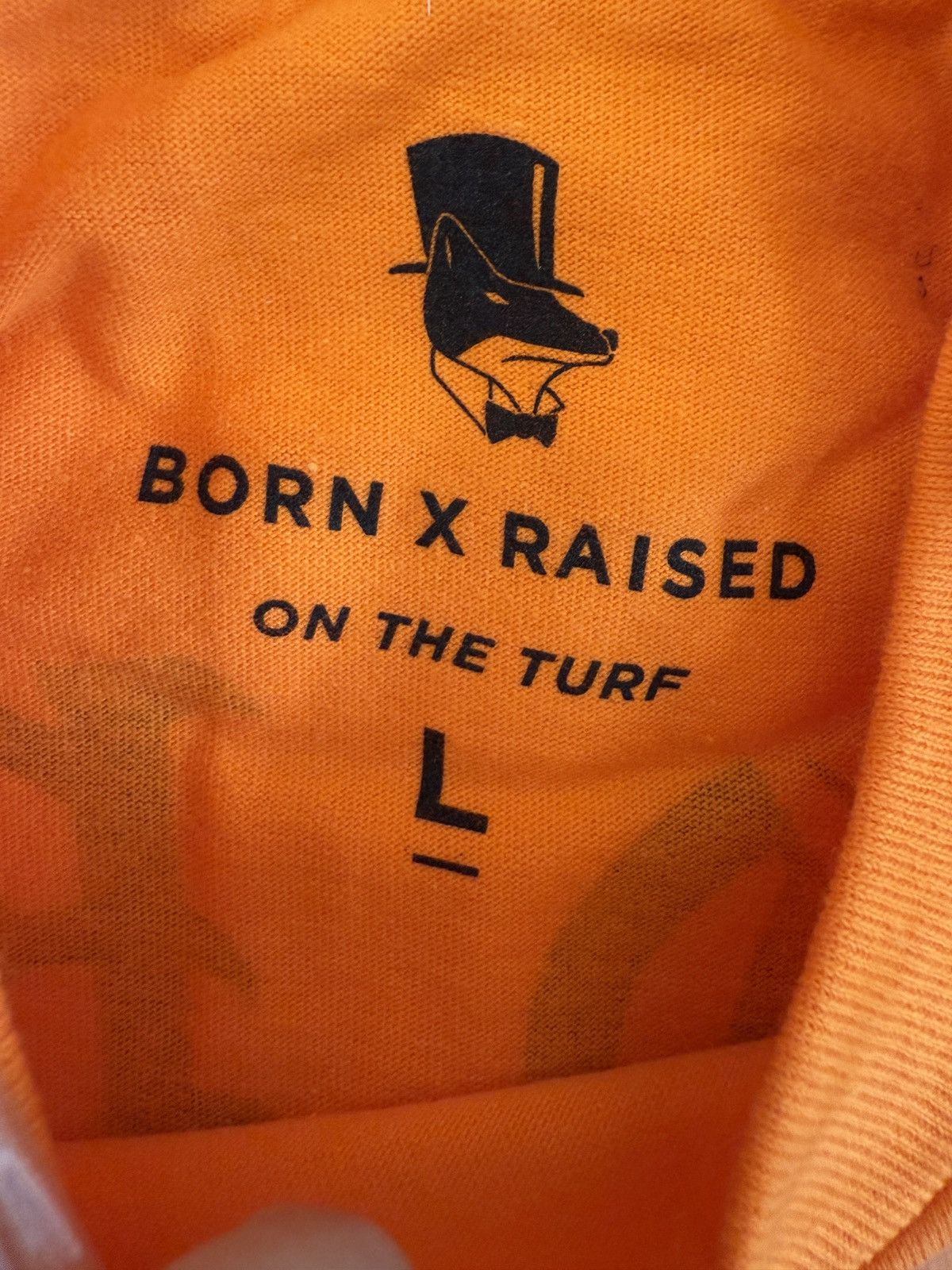 Born X Raised BORN X RAISED ON THE TURF BXR ROCKER TEE ORANGE- Size L Size US L / EU 52-54 / 3 - 4 Thumbnail