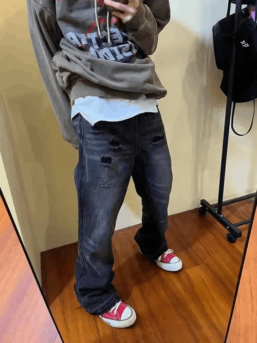 Washed black flared jeans with raw edges