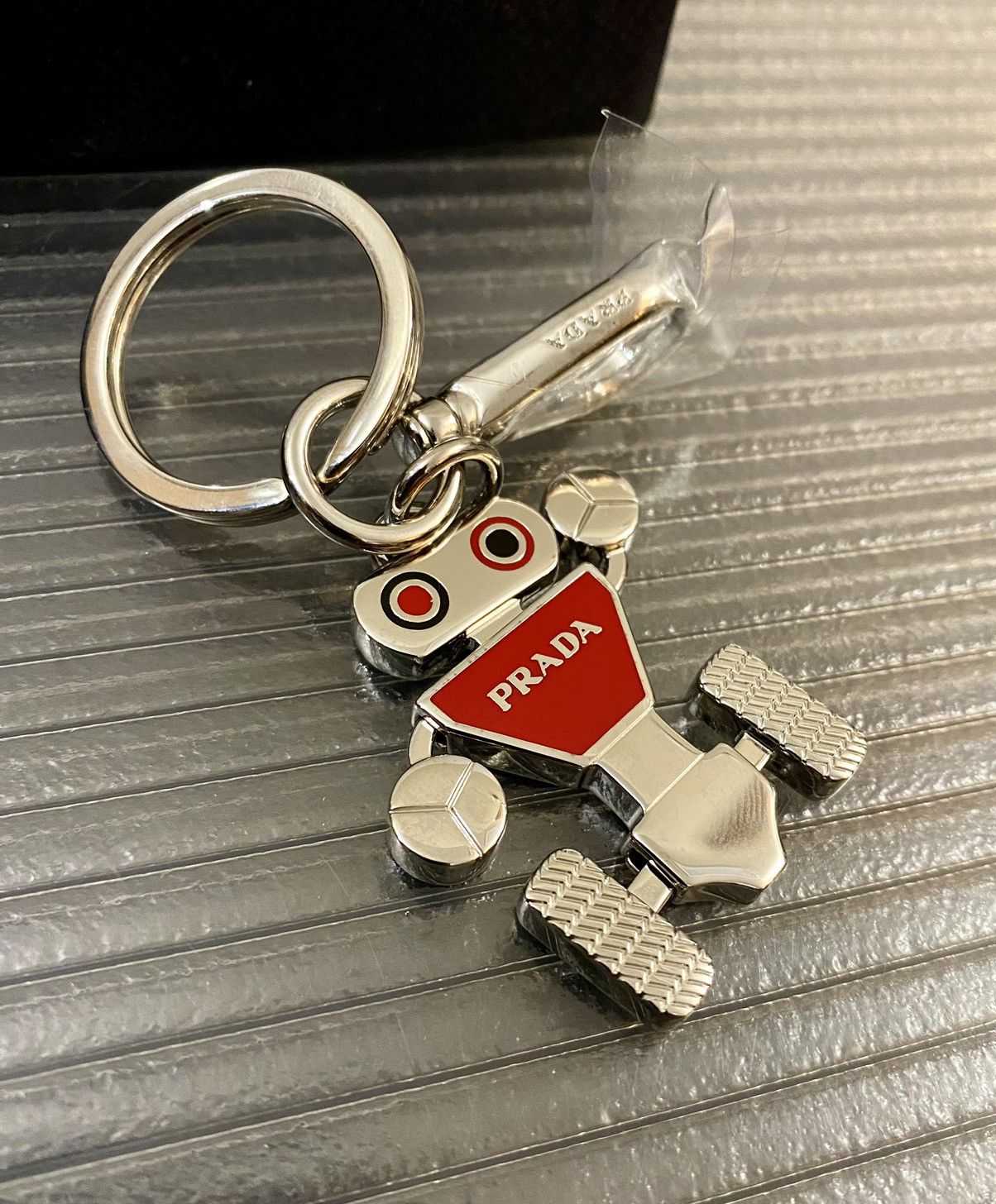 Prada 🇮🇹 silver og metal robot swivel bag charm/keychain NEW