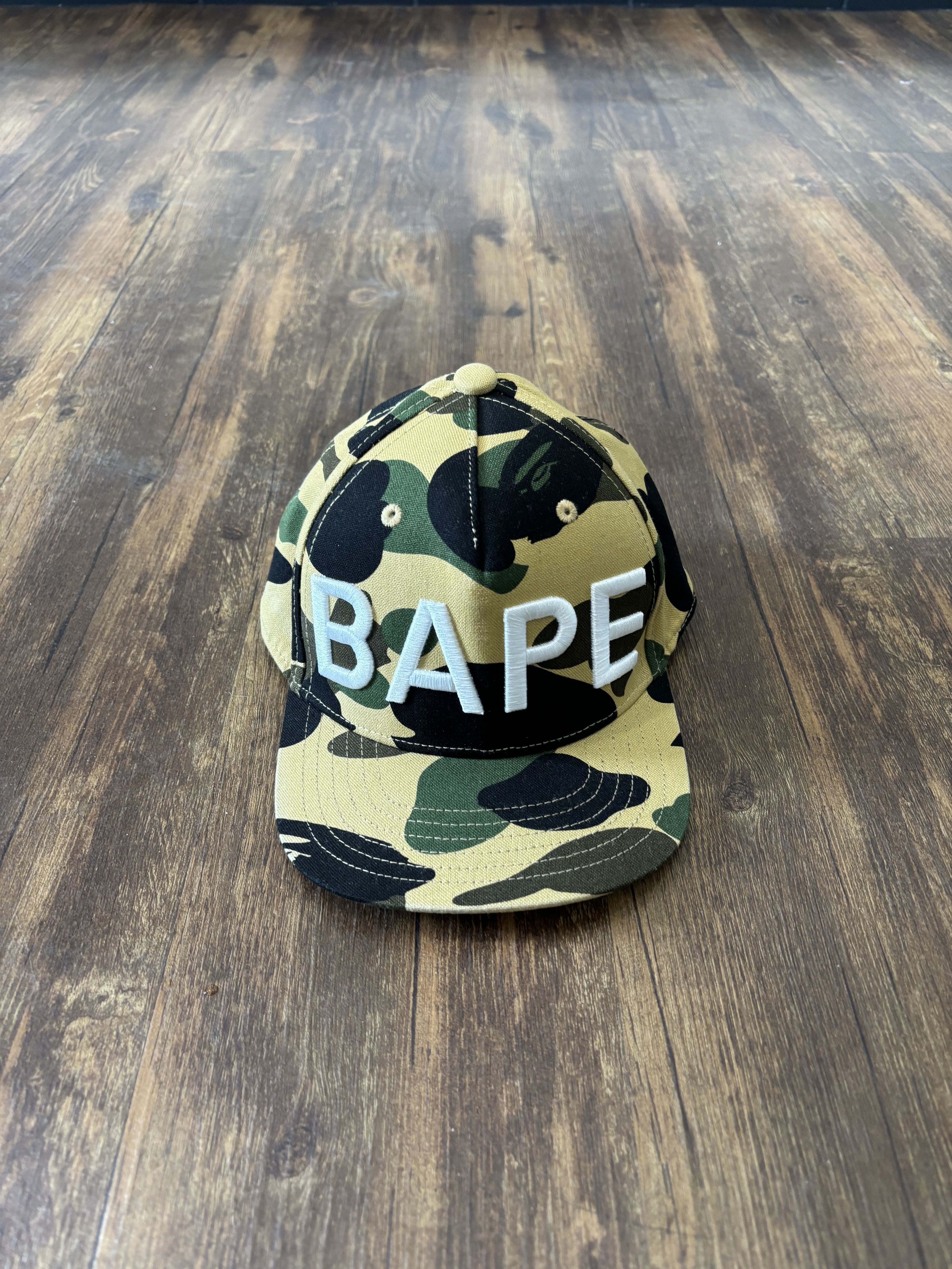 image of Bape 1St Camo Snapback Cap in Yellow, Men's