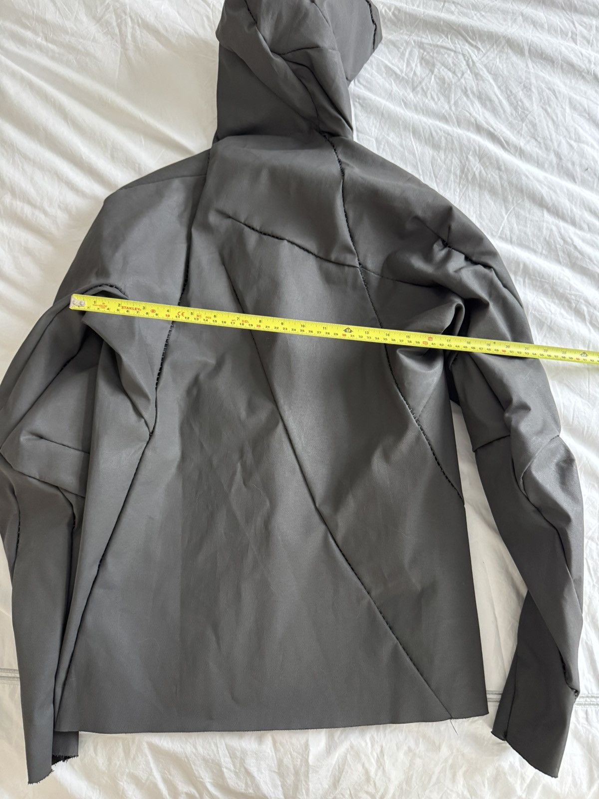 Unlined hand stitched hooded jacket.