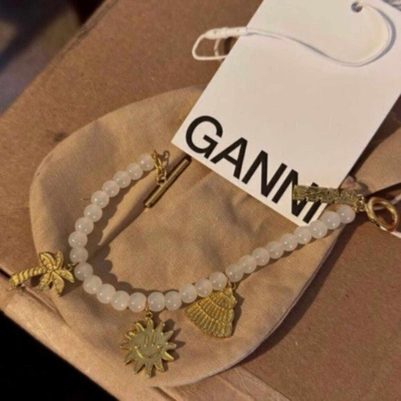 Ganni Ganni White beaded bracelet with gold charms Size ONE SIZE - 6 Thumbnail