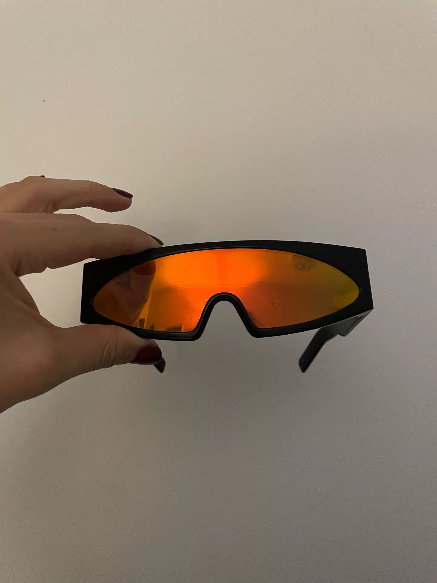 Rick Owens futuristic sunglasses with orange lenses