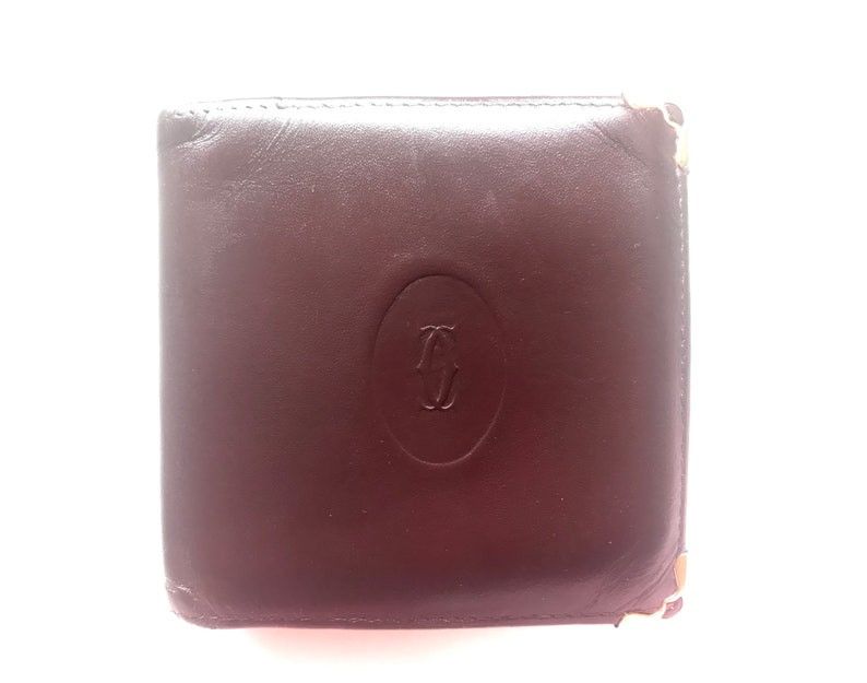 image of Vintage Cartier, Must De Cartier Wine Leather Square Wallet With Gold Tone Frames. Unisex Use in Bl