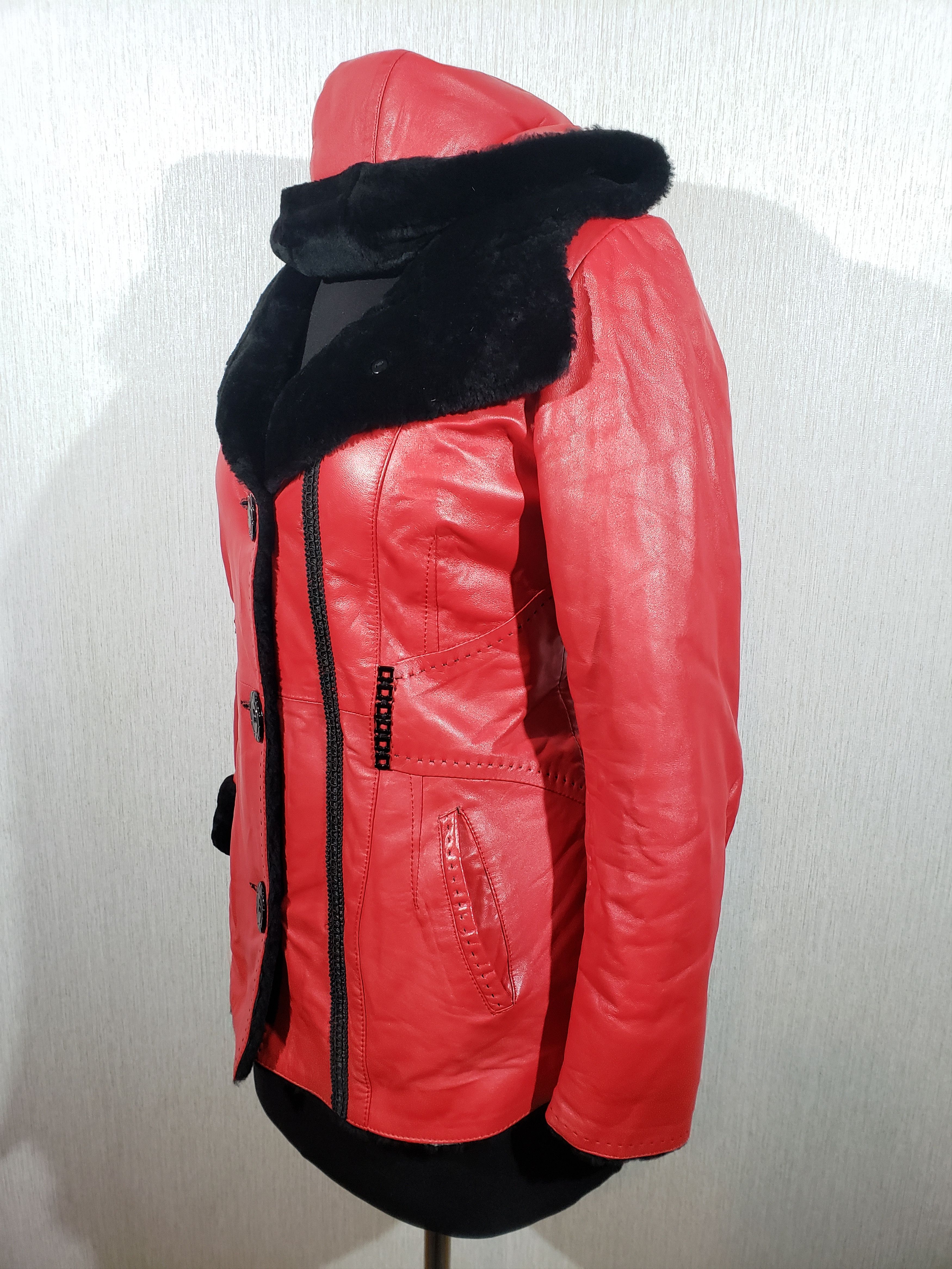 Stylish women's red sheepskin coat with a hood. Fur Faux Fur
