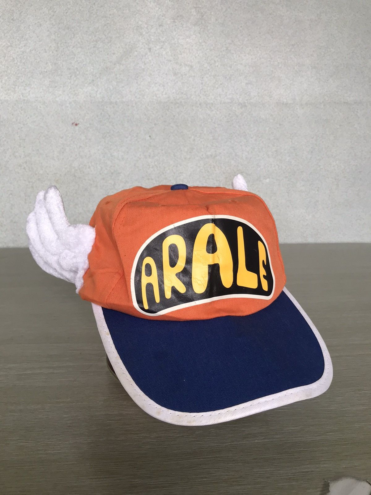 image of Anima x Cartoon Network Official Dr.slump Arale Wing Hats in Blue/Orange, Men's