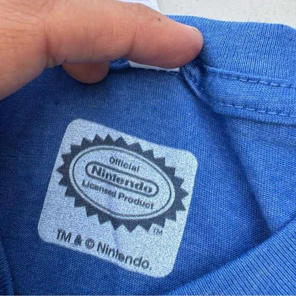 Nintendo NEW SUPER MARIO BROS NINTENDO MUSHROOMS BLUE T-SHIRT SZ MEDI Size US M / EU 48-50 / 2 - 5 Thumbnail