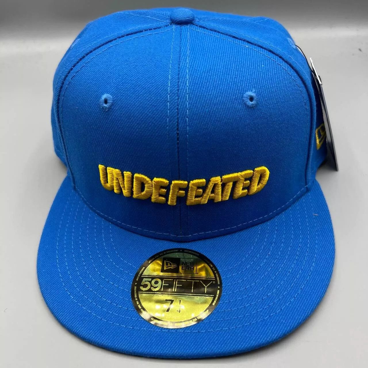 New Era Undefeated Hat Men 7 1/4 Blue 59Fifty New Era Fitted Cap 