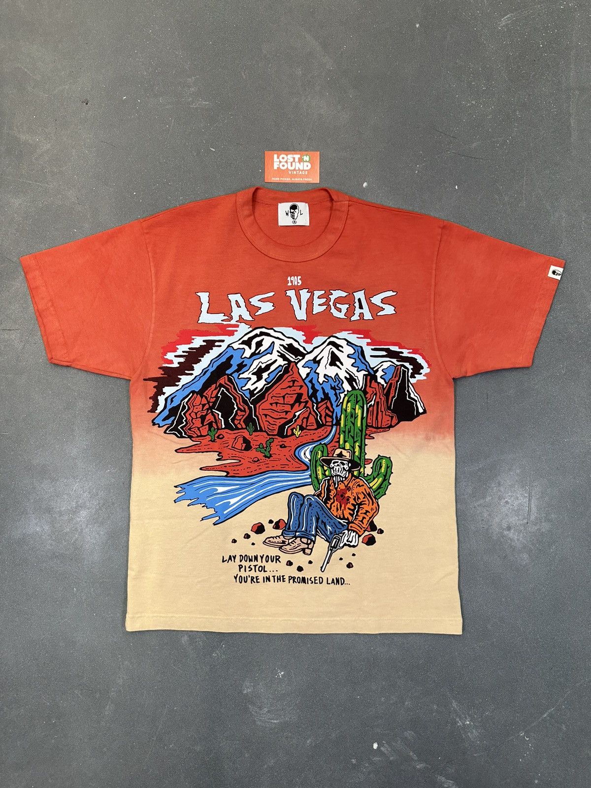 image of Warren Lotas Las Vegas Is A Mirage Lay Down Your Pistol Tee in Tie/Dye, Men's (Size Medium)
