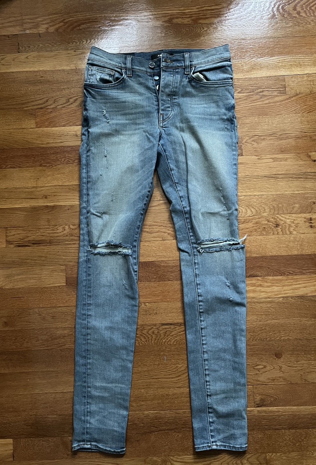 image of Amiri Ripped Knee Denim Jeans in Blue, Men's (Size 31)