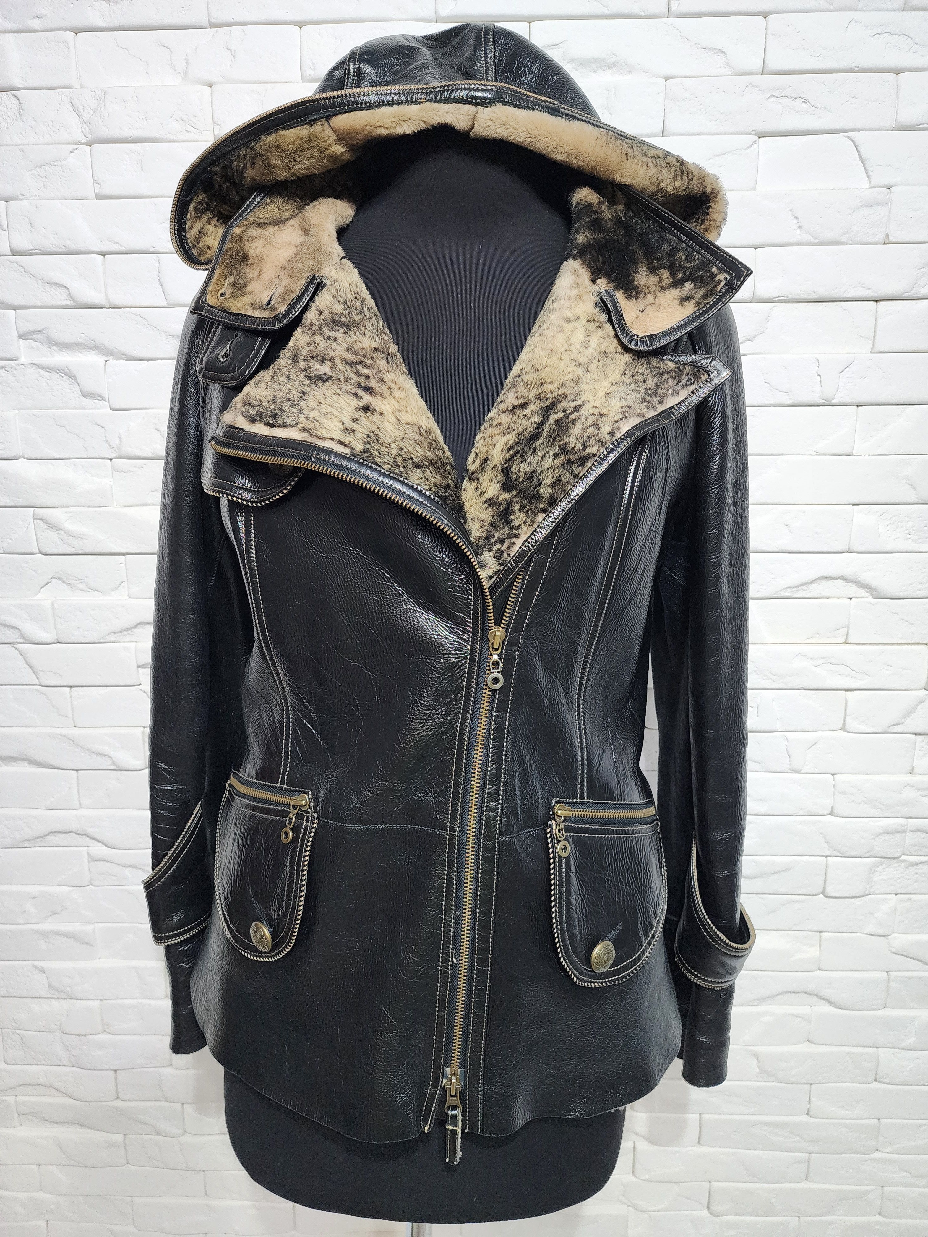Black sheepskin coat with a metal zipper and hood.