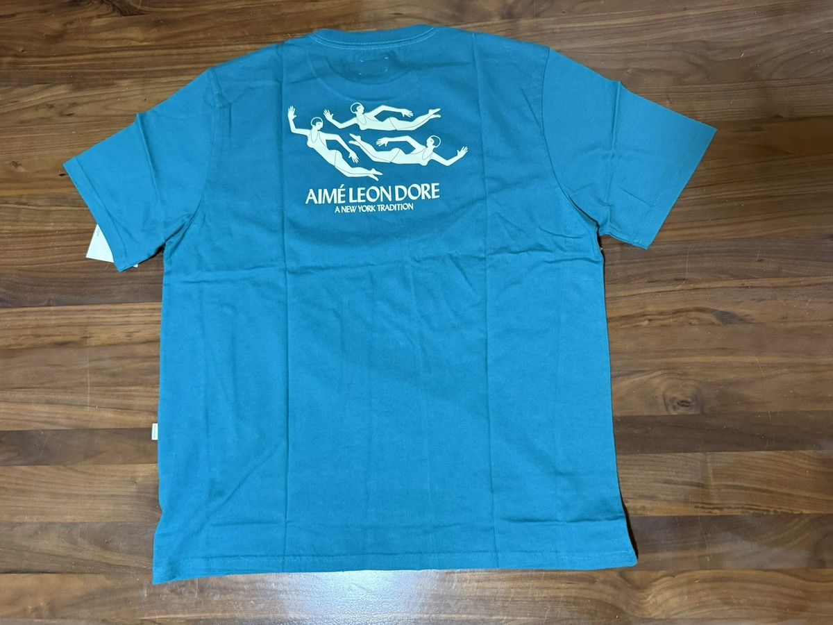 Aime Leon Dore Aime Leon Dore ALD Swimmers Tee “Kayaking” (Teal) Size XL Size US XL / EU 56 / 4 - 11 Thumbnail