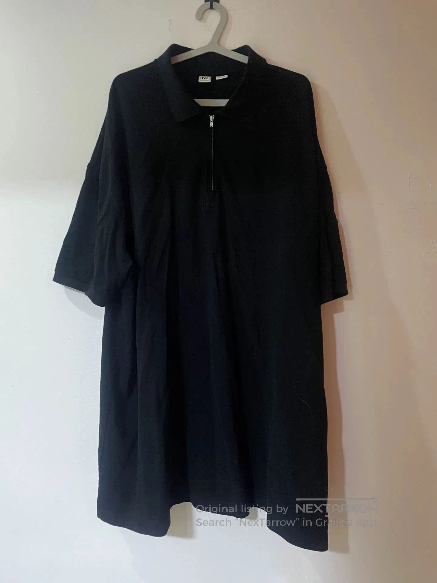 oversized black polo shirt with unique design.
