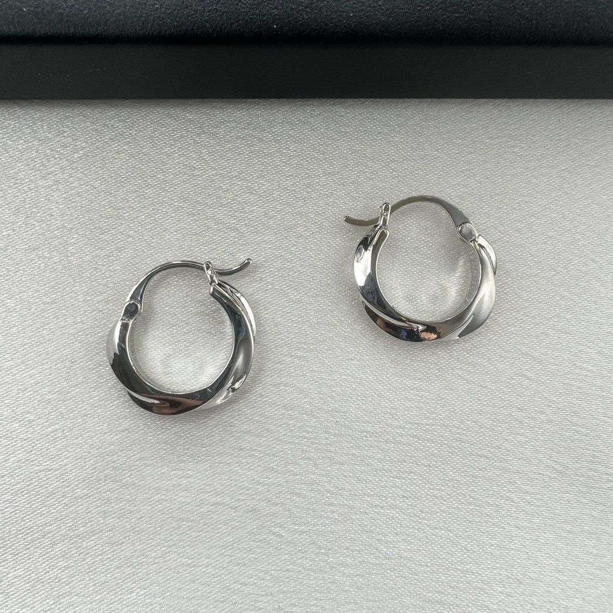 Designer Twisted Silver Hoop Earrings for Women Size ONE SIZE - 1 Thumbnail